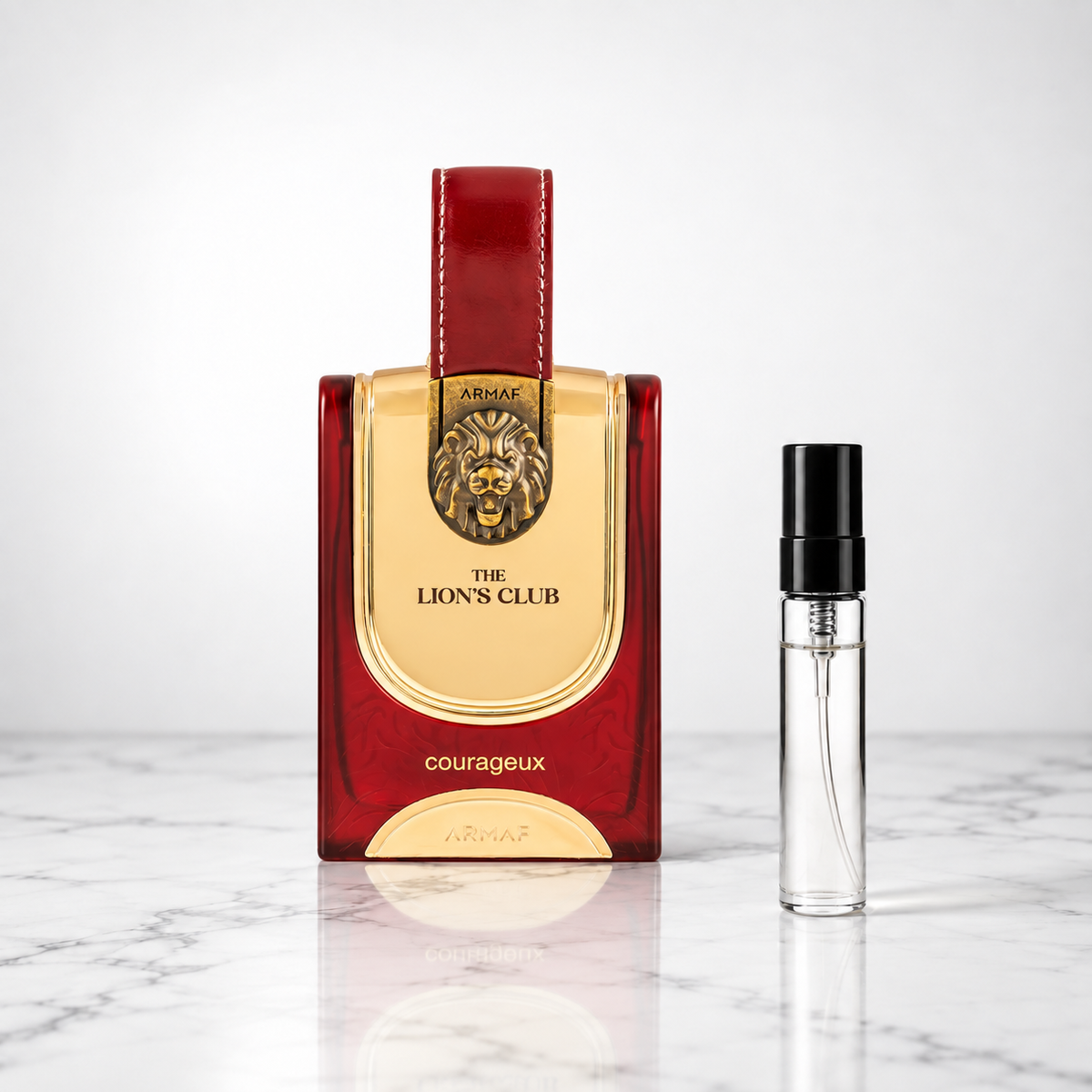 courageux perfume bottle beside a 5ml decant on white marble