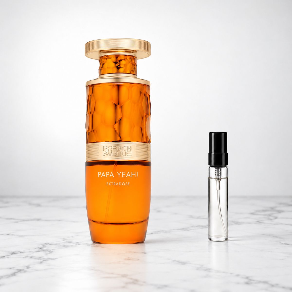 Papa Yeah! Extradose by French Avenue perfume bottle beside a sample decant on white marble