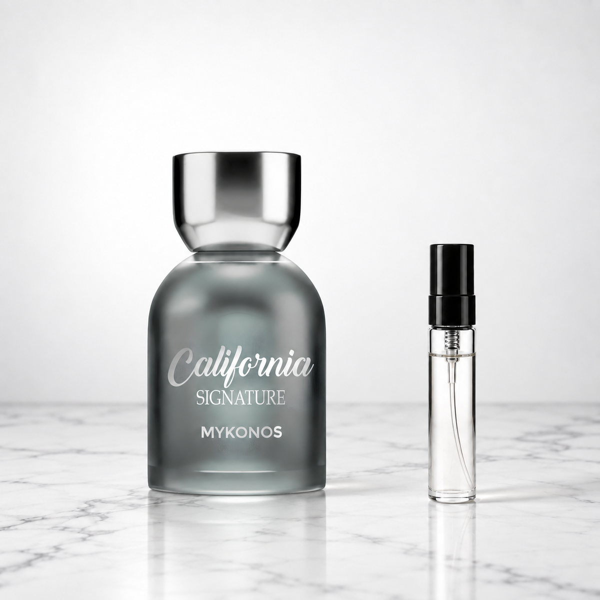 California Signature by Mykonos bottle beside a perfume sample decant on marble