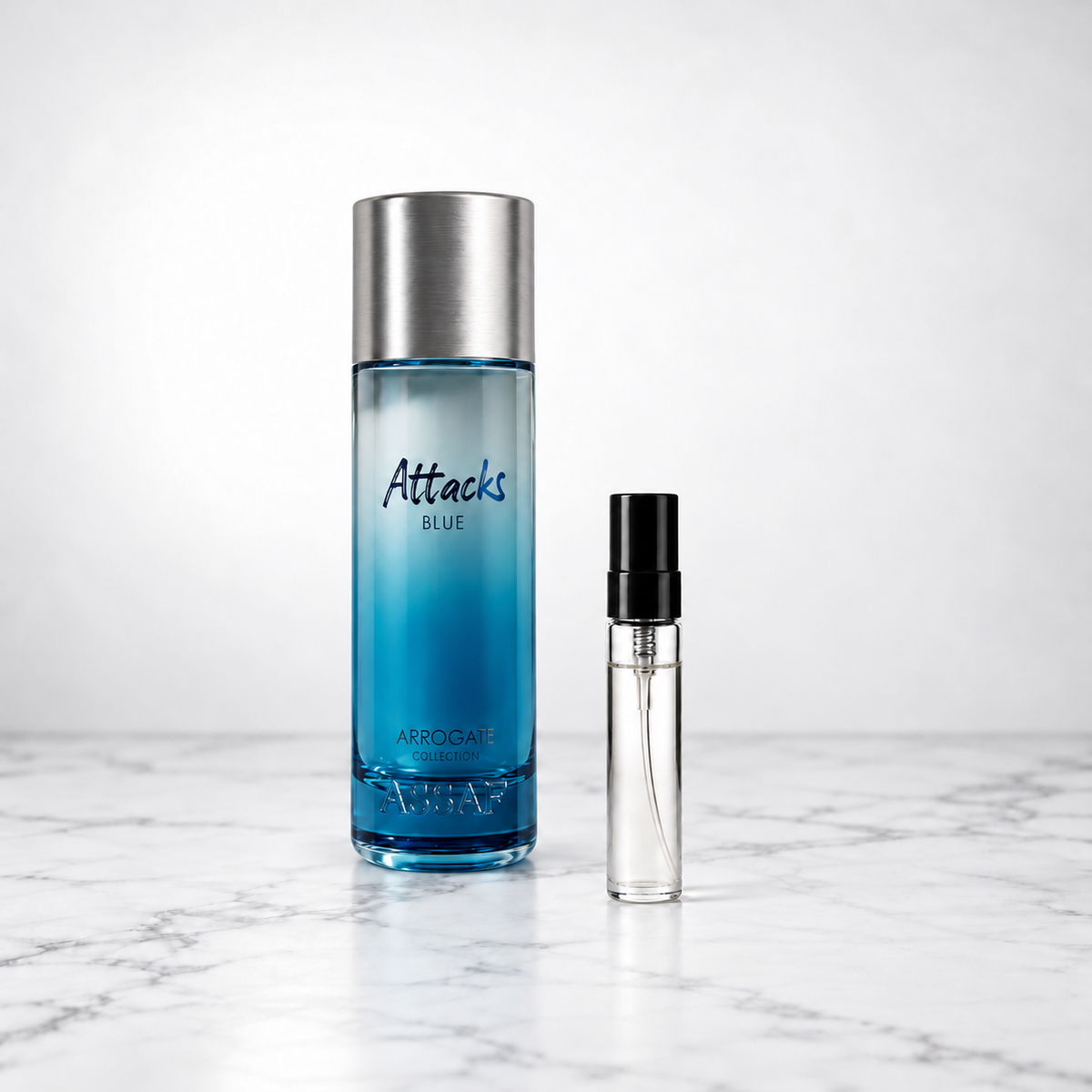 Attacks Blue by Assaf bottle beside a capped sample decant on white marble