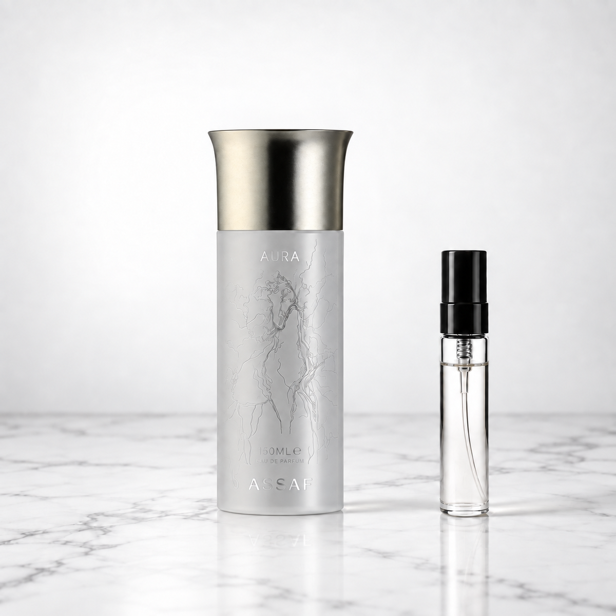 Aura Pegasus by Assaf bottle beside a perfume sample decant on marble