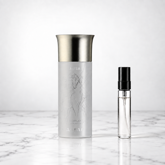 Aura Pegasus by Assaf bottle beside a perfume sample decant on marble