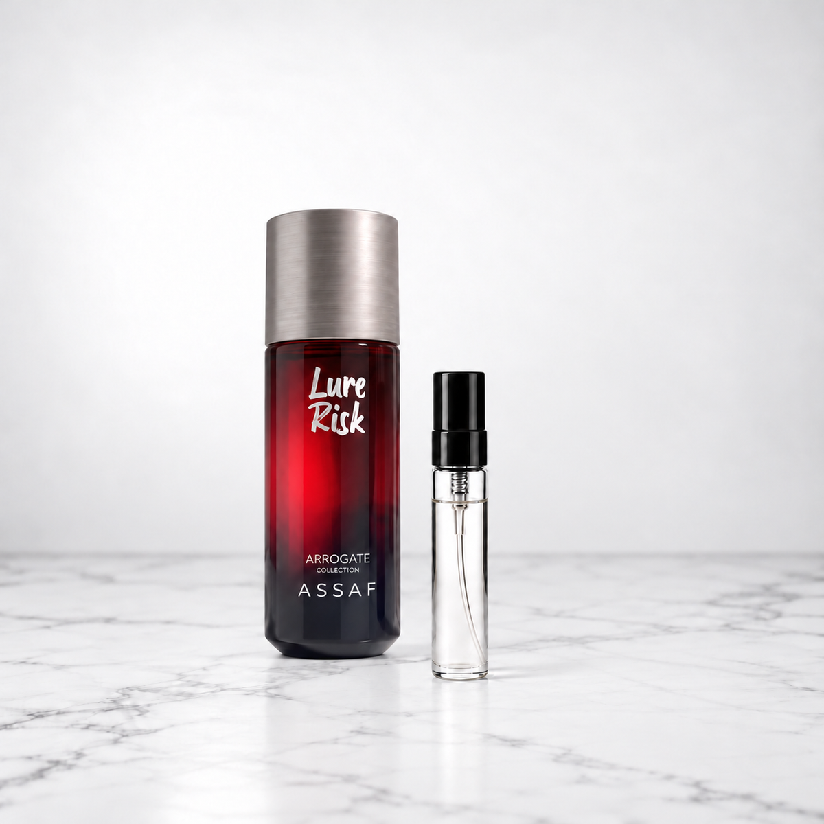 Lure Risk by Assaf bottle beside a capped sample decant on white marble