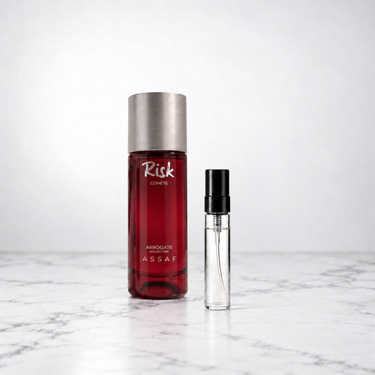 Risk Comete by Assaf bottle beside a capped sample decant on white marble