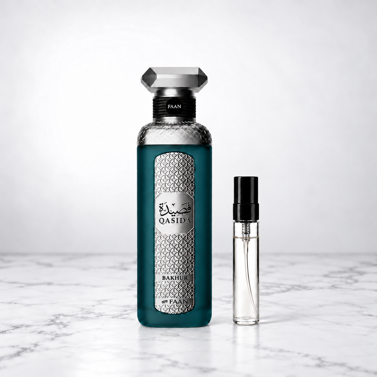 Qasida Bakhour by FAAN perfume bottle beside a capped sample decant on white marble