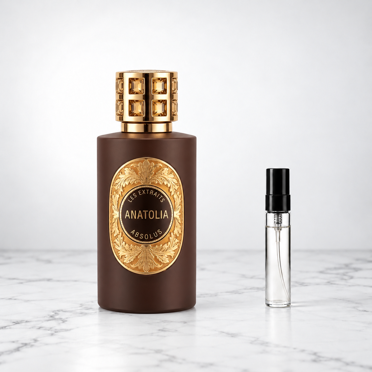 Anatolia by French Avenue perfume bottle beside a sample decant on white marble