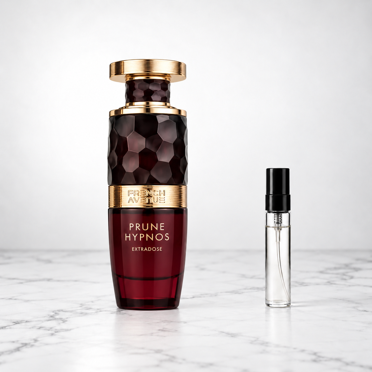 Prune Hypnose Extradose by French Avenue perfume bottle beside a sample decant on white marble