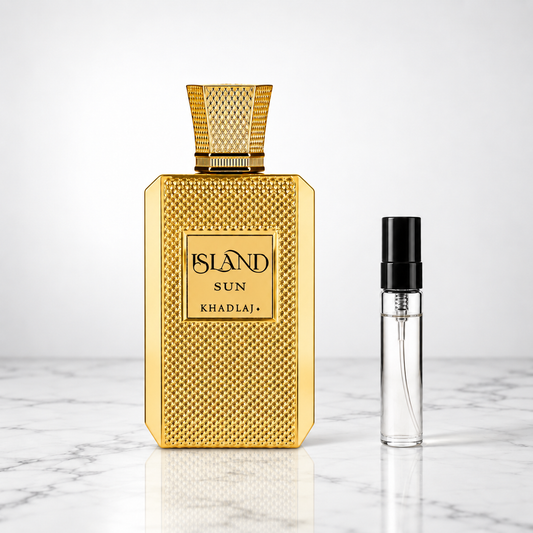 island sun perfume bottle beside a 5ml decant on white marble