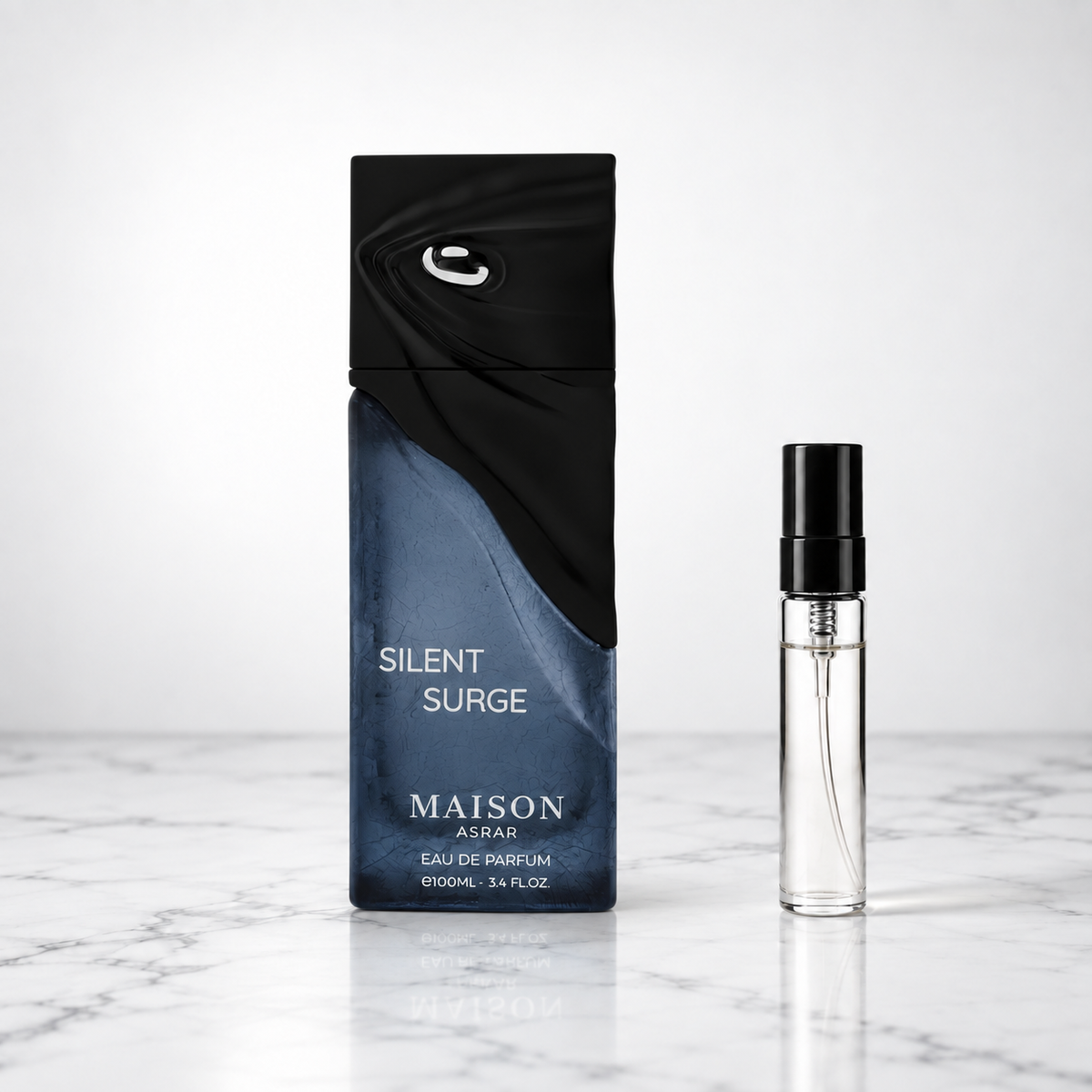 silent surge perfume bottle beside a 5ml decant on white marble
