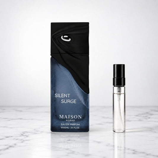 silent surge perfume bottle beside a 5ml decant on white marble